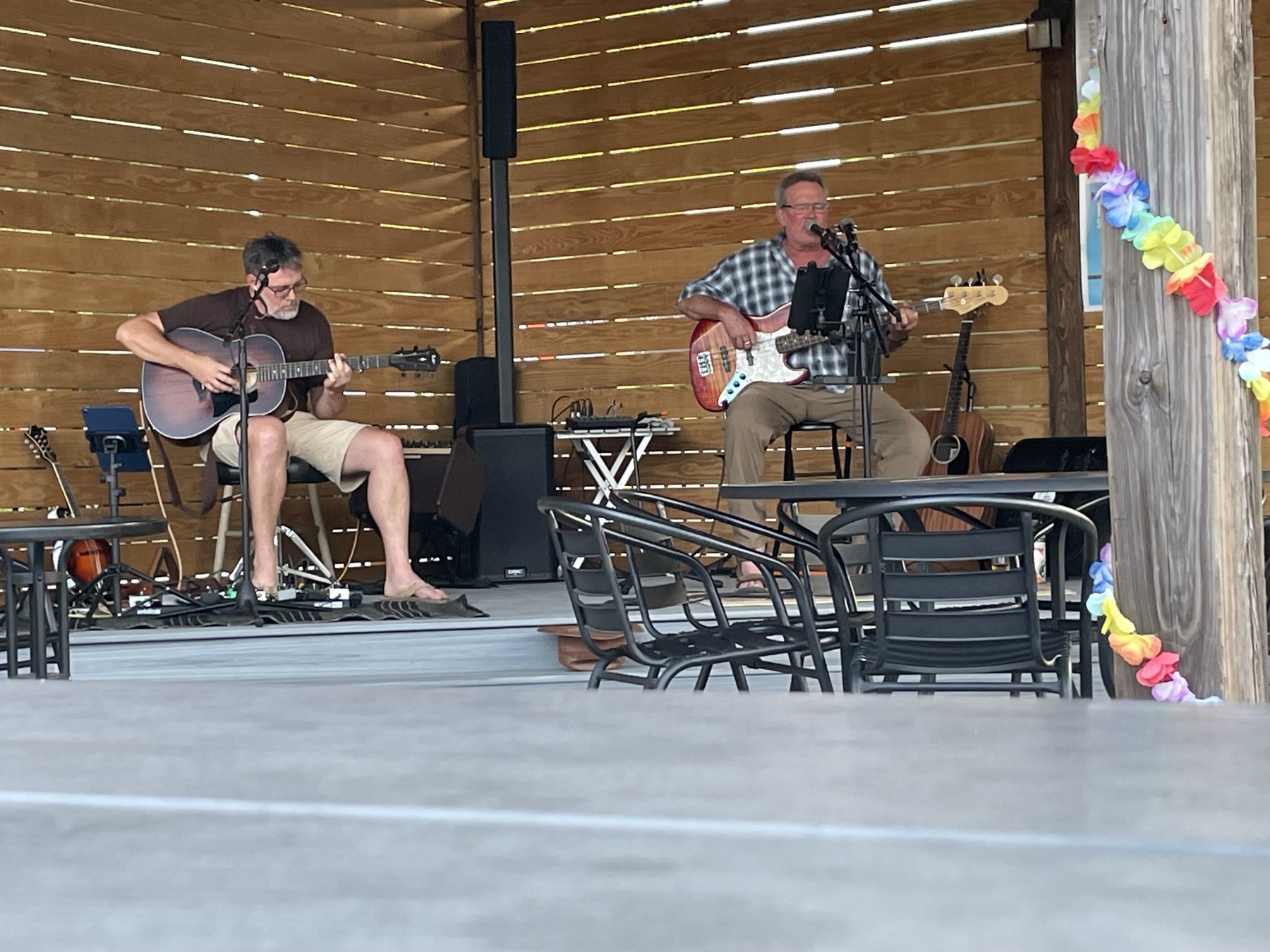 Double Dog Dare playing an afternoon set on a covered patio stage